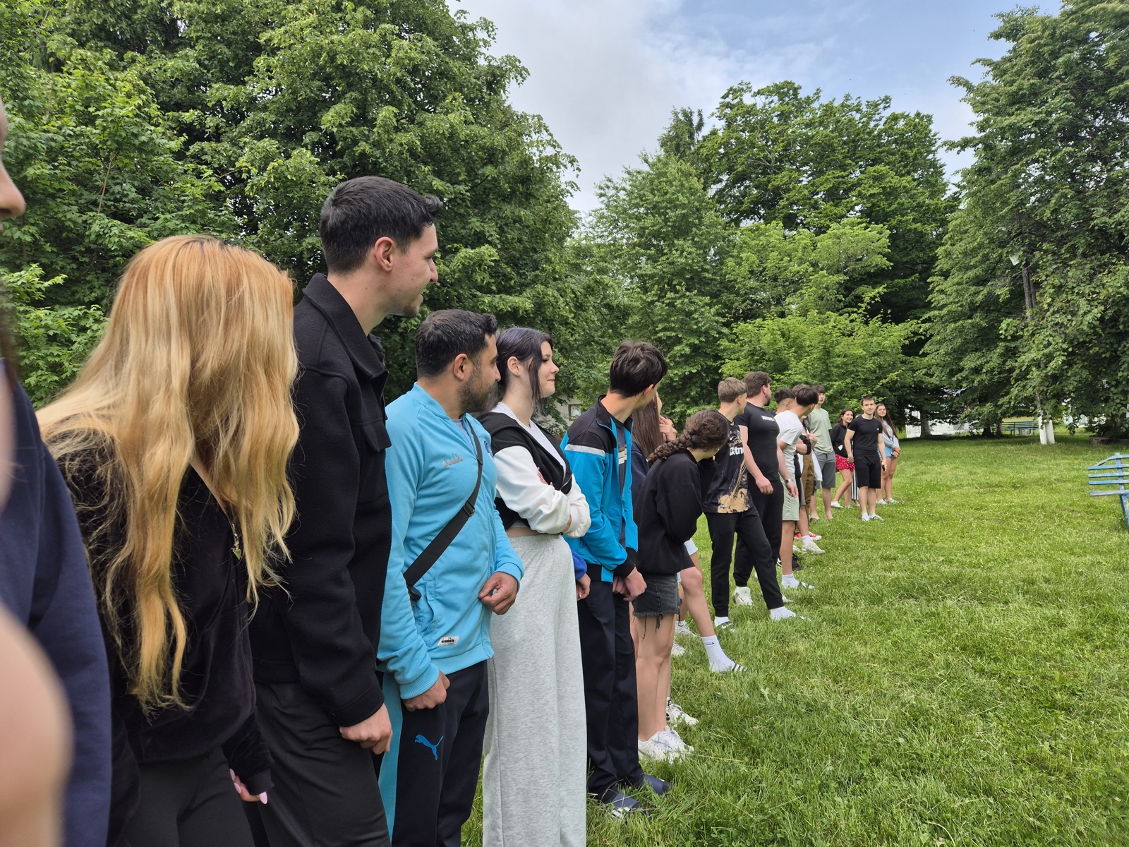 Participants laughing while lining up in silence during a name-order game
