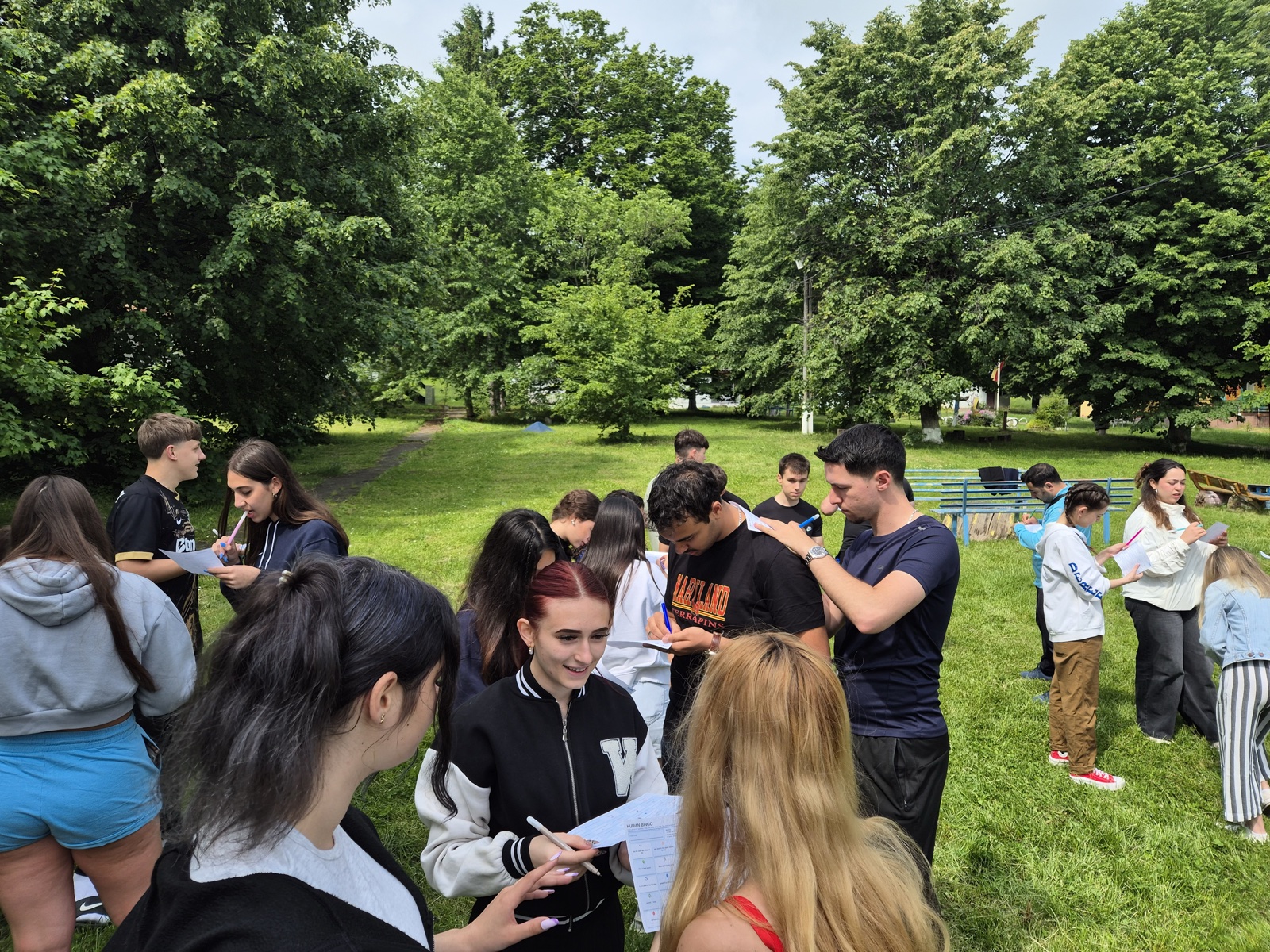 Participants mingle and sign each other's Bingo sheets on their backs