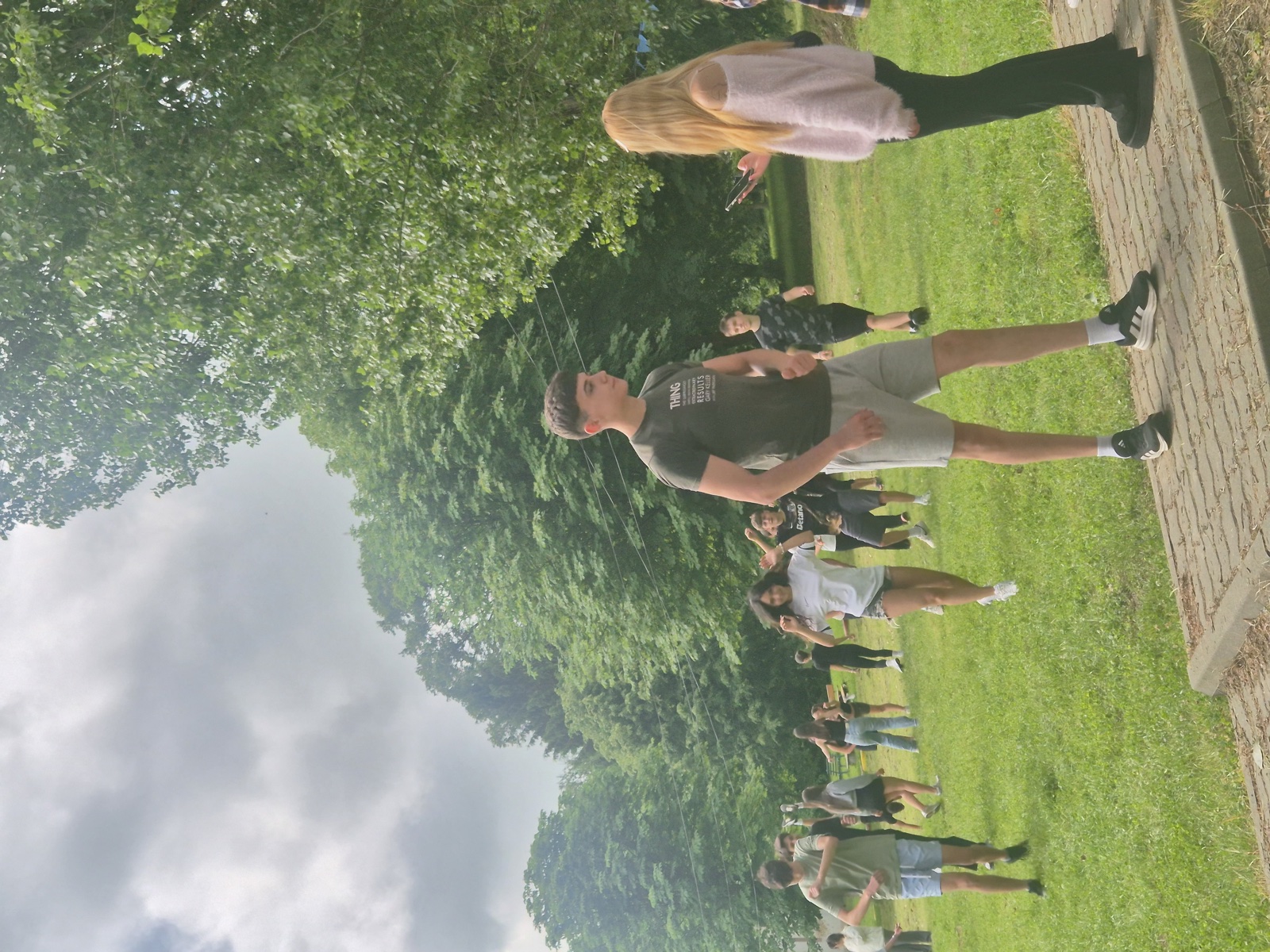 Participants run across the grass during Greek and Romanian childhood games