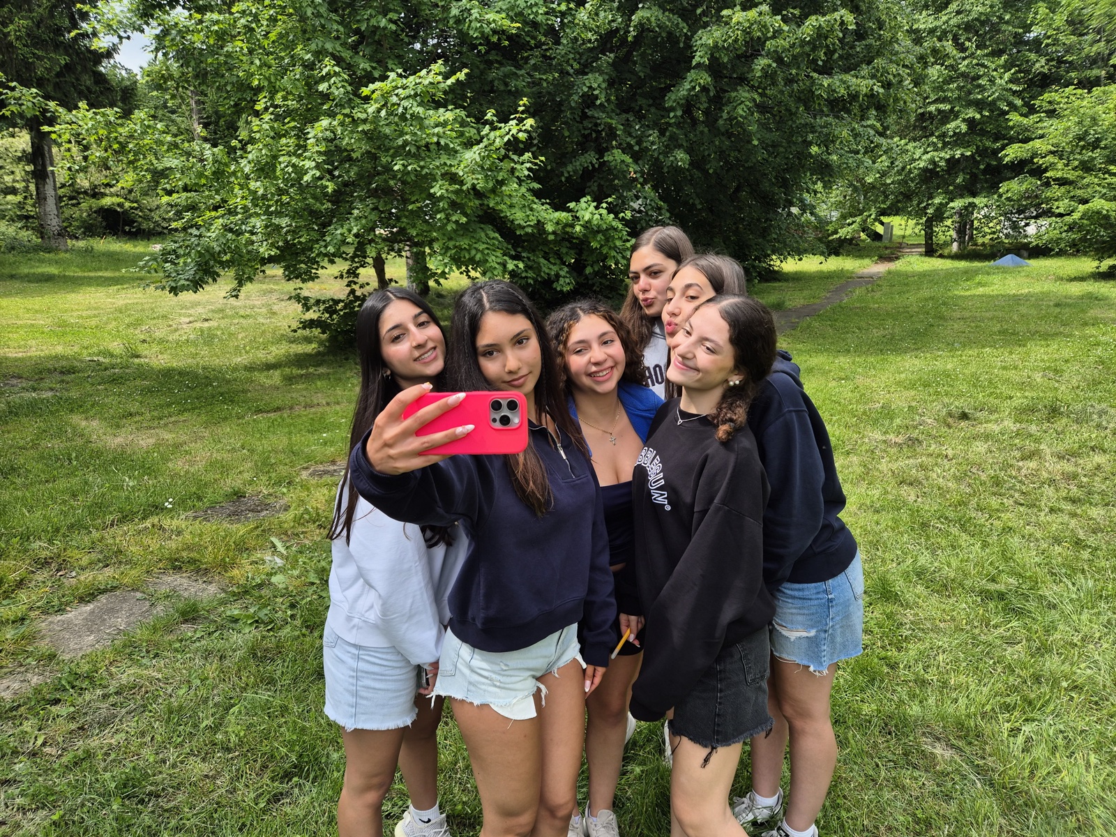 Six participants squeeze into a sunny selfie on day one