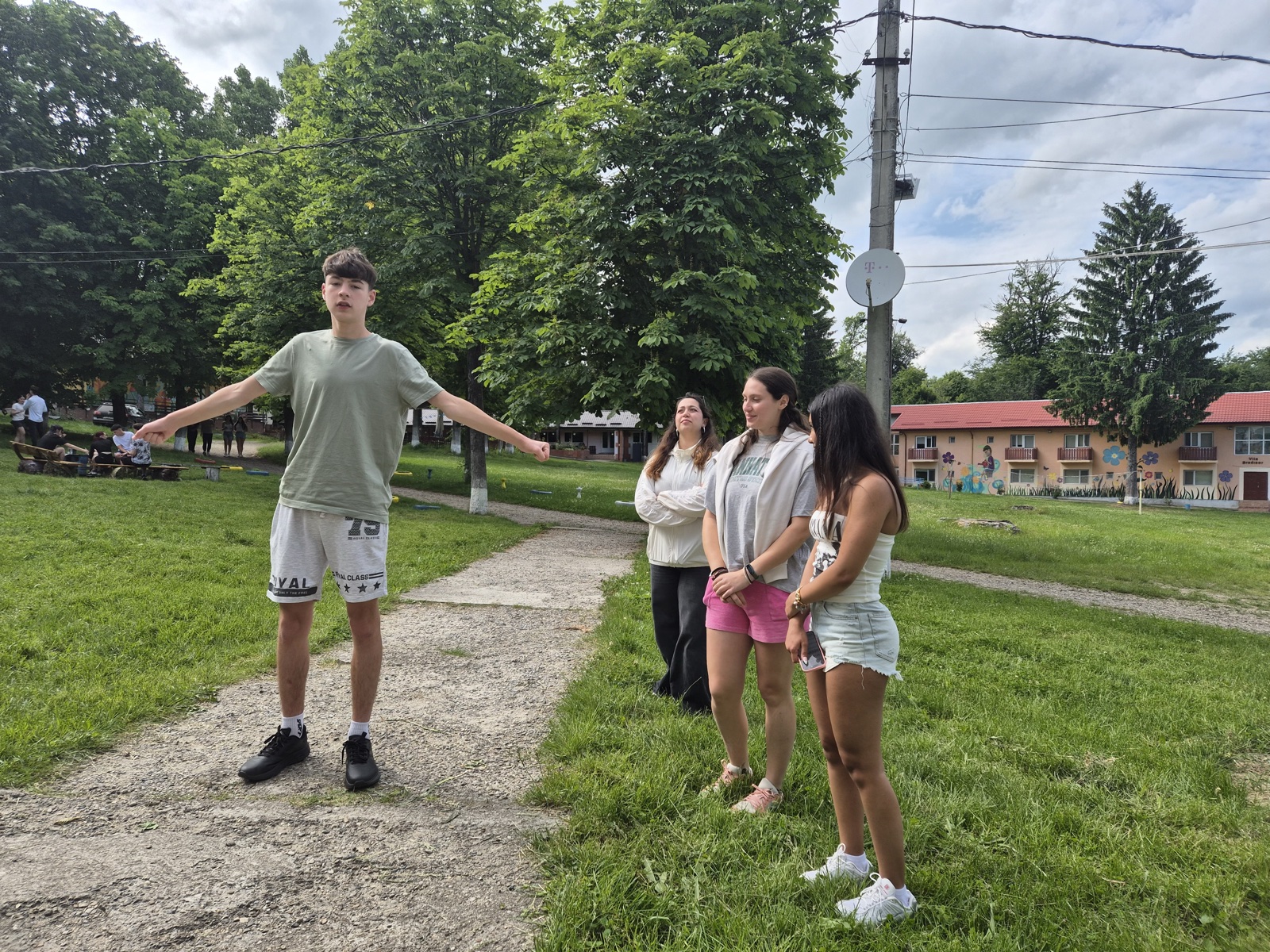 Arms-linked circle in front of the camp mural