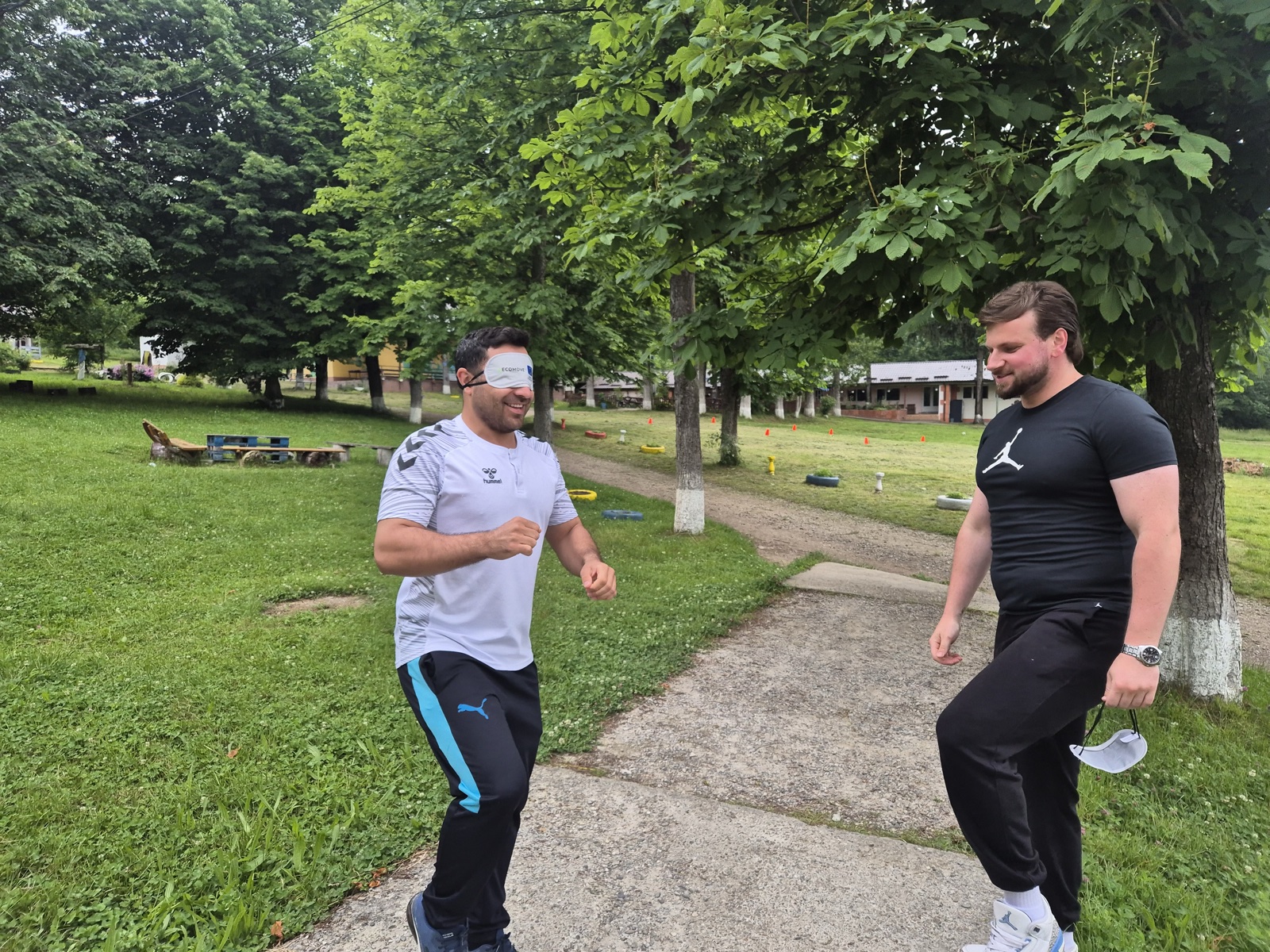 A blindfolded participant grins while navigating toward a voice